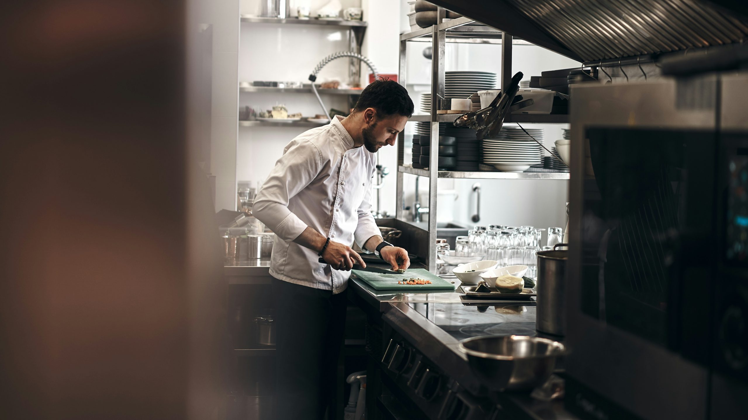Chef plating a dish in a professional kitchen